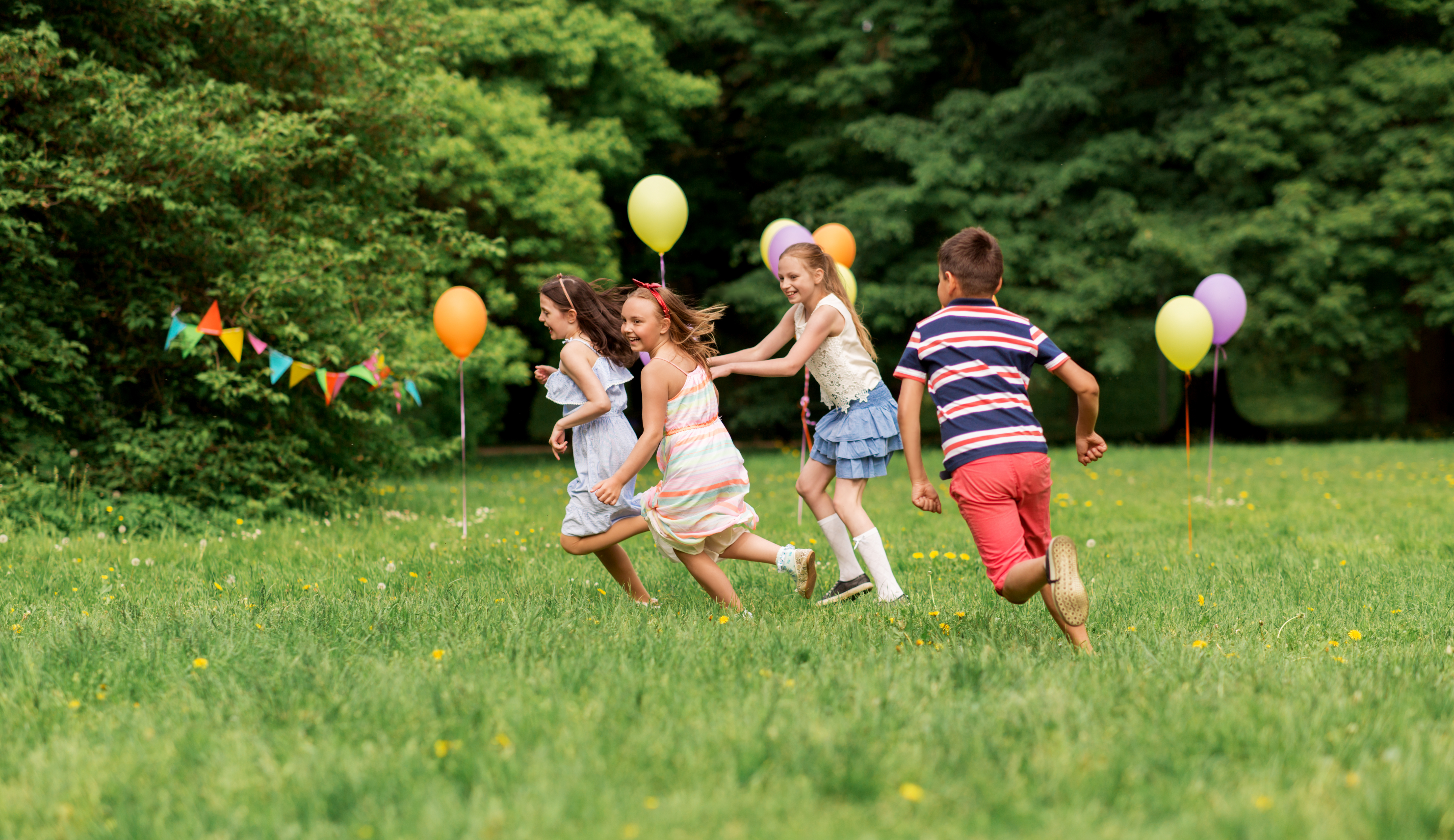 happy kids playing tag game at birthday party
